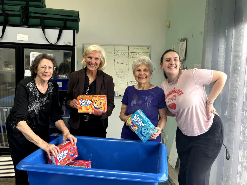 photo volunteers food pantry donation kool aid jammers